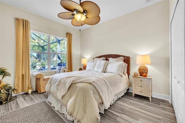 13491 Palmetto Grove Dr, Fort Myers, FL 33905 4th bedroom in rear of home overlooking the pool deck. Hardwood tile flooring.
