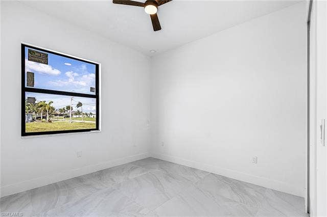 4116 36th Ln, Cape Coral, FL 33993 Window with black trim, ceiling fan with light, recessed lighting, light-toned tile flooring, and white walls