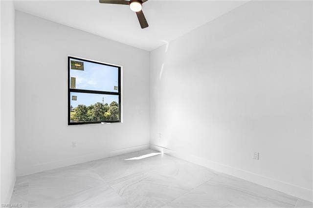 4116 36th Ln, Cape Coral, FL 33993 Tile flooring, large window, ceiling fan, and white walls