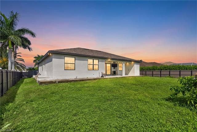 113 38 Pl, Cape Coral, FL 33993 Expansive rear lawn, covered patio, and perimeter fencing