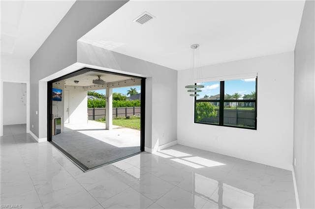 113 38 Pl, Cape Coral, FL 33993 Spacious room featuring large format tile flooring and a multi-pane window