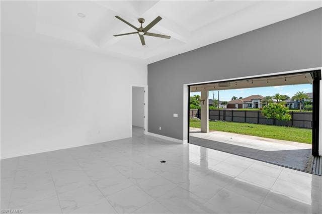 113 38 Pl, Cape Coral, FL 33993 Recessed ceiling with a modern ceiling fan, large format tile flooring, and a sliding glass wall opening to a covered patio