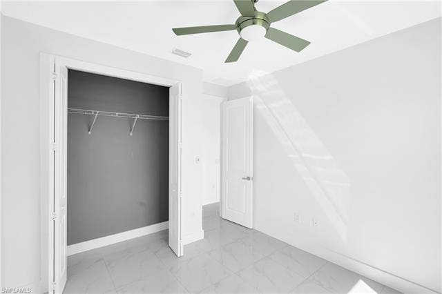 113 38 Pl, Cape Coral, FL 33993 White walls, tile flooring, a ceiling fan, and a closet with wire shelving