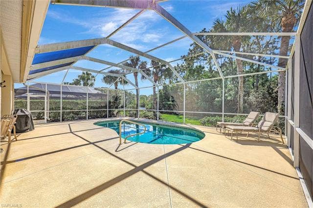 9375 Oak Strand Dr, Estero, FL 34135 Pool featuring a lanai and a patio