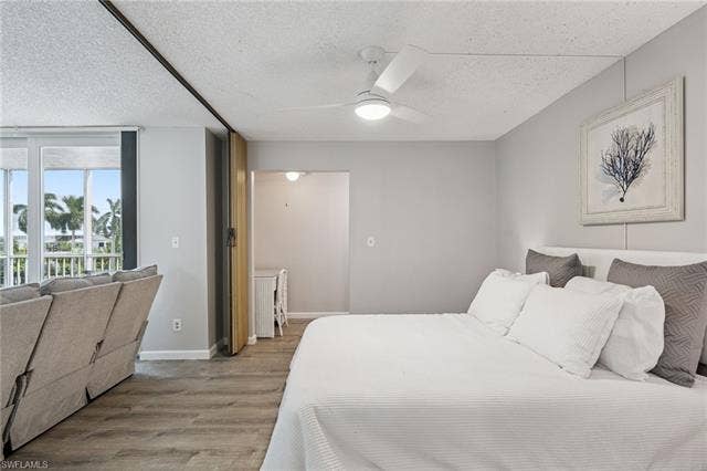 5500 Bonita Beach Rd, #308, Bonita Springs, FL 34134 Wood-finish flooring throughout, with a ceiling-mounted fan and integrated lighting