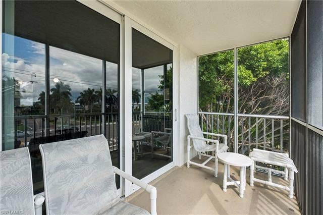 5500 Bonita Beach Rd, #308, Bonita Springs, FL 34134 Screened balcony with sliding glass doors and concrete flooring
