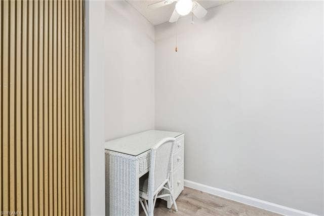 5500 Bonita Beach Rd, #308, Bonita Springs, FL 34134 Wood-finish flooring with a white baseboard trim