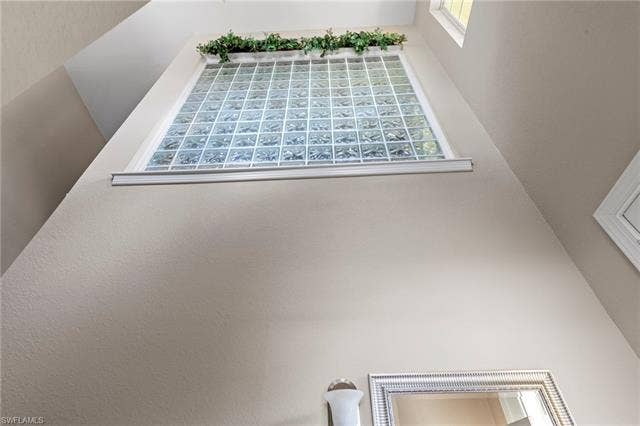 26485 Lucky Stone Rd, #202, Bonita Springs, FL 34135 High wall with a glass block window and high-set accent window
