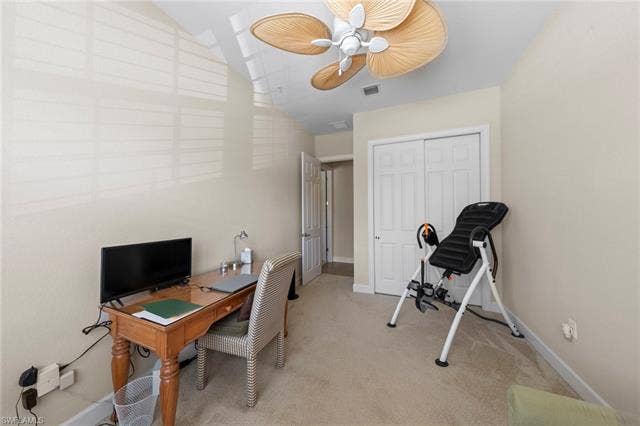 26485 Lucky Stone Rd, #202, Bonita Springs, FL 34135 Carpeted room with a vaulted ceiling, ceiling fan, and white bi-fold closet doors
