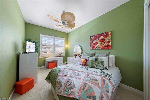 26485 Lucky Stone Rd, #202, Bonita Springs, FL 34135 White window shutters, neutral carpeting, and a built-in ceiling fan with a light fixture