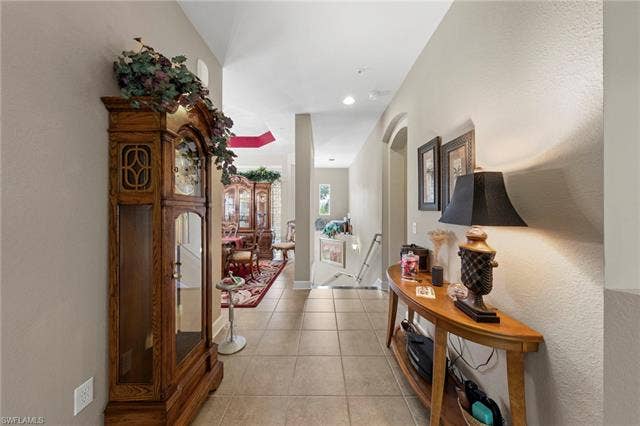26485 Lucky Stone Rd, #202, Bonita Springs, FL 34135 Tiled flooring, arched doorway, recessed lighting, and a console table