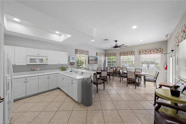 26485 Lucky Stone Rd, #202, Bonita Springs, FL 34135 White cabinetry, undermount sink, recessed lighting, ceiling fan, and tile flooring