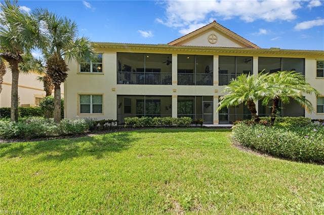 26485 Lucky Stone Rd, #202, Bonita Springs, FL 34135 Two-story exterior with expansive screened lanais on both levels and a symmetrical upper-level balcony