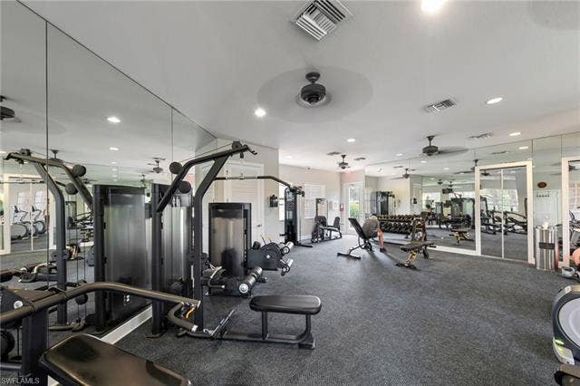 26485 Lucky Stone Rd, #202, Bonita Springs, FL 34135 Fitness room featuring wall-to-wall mirrors, recessed lighting, ceiling fans, and durable flooring