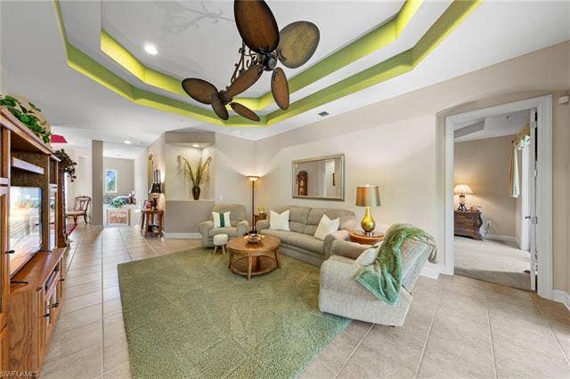 26485 Lucky Stone Rd, #202, Bonita Springs, FL 34135 Tray ceiling with integrated lighting, tiled flooring, built-in display cabinetry, ceiling fan