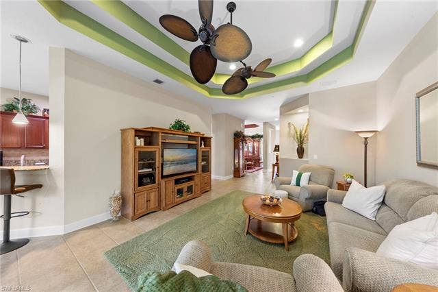 26485 Lucky Stone Rd, #202, Bonita Springs, FL 34135 Tray ceiling with accent lighting and a ceiling fan, tile flooring, and recessed lighting