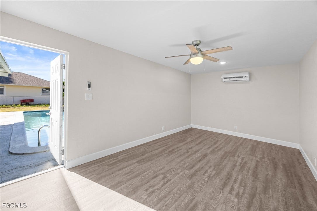 2514 SE 26th Avenue, Cape Coral, FL 33904 Unfurnished room featuring light wood-type flooring, ceiling fan, and an AC wall unit