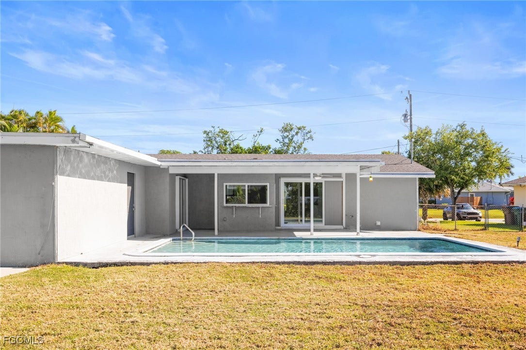 2514 SE 26th Avenue, Cape Coral, FL 33904 Rear view of property featuring a patio, an outdoor pool, and stucco siding
