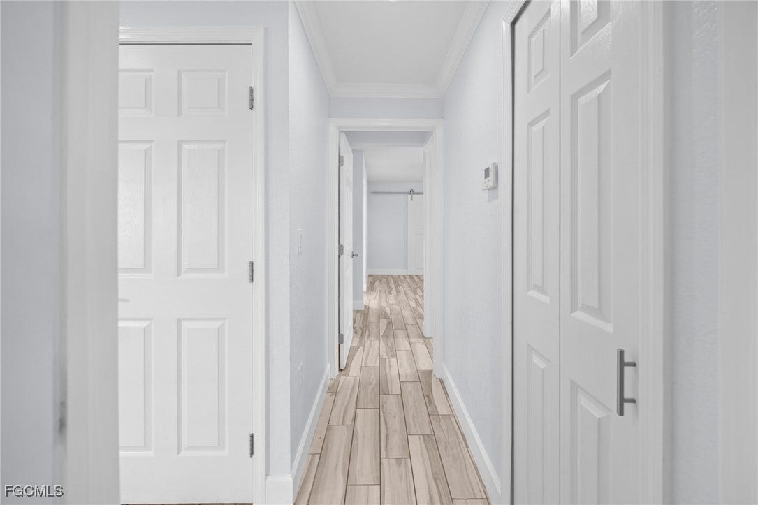 2514 SE 26th Avenue, Cape Coral, FL 33904 Corridor with wood finish floors and ornamental molding