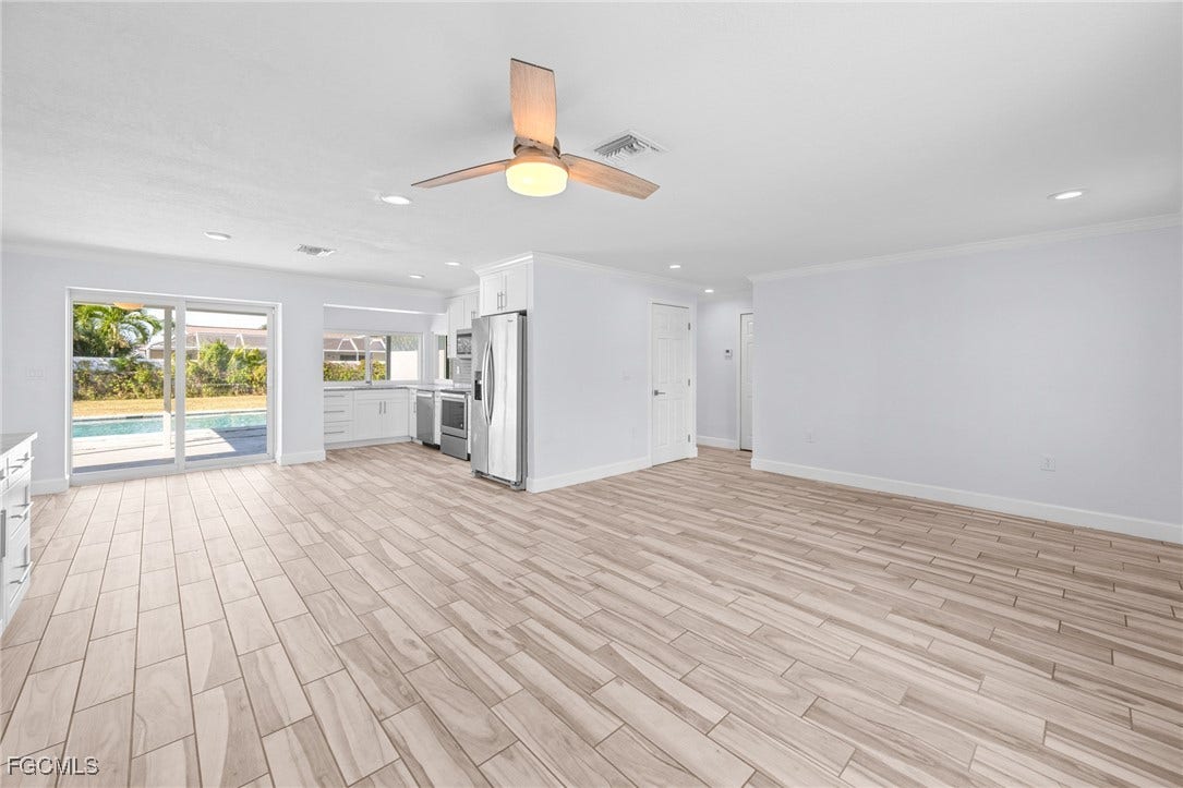 2514 SE 26th Avenue, Cape Coral, FL 33904 Unfurnished living room featuring light wood-style flooring, a ceiling fan, crown molding, and recessed lighting
