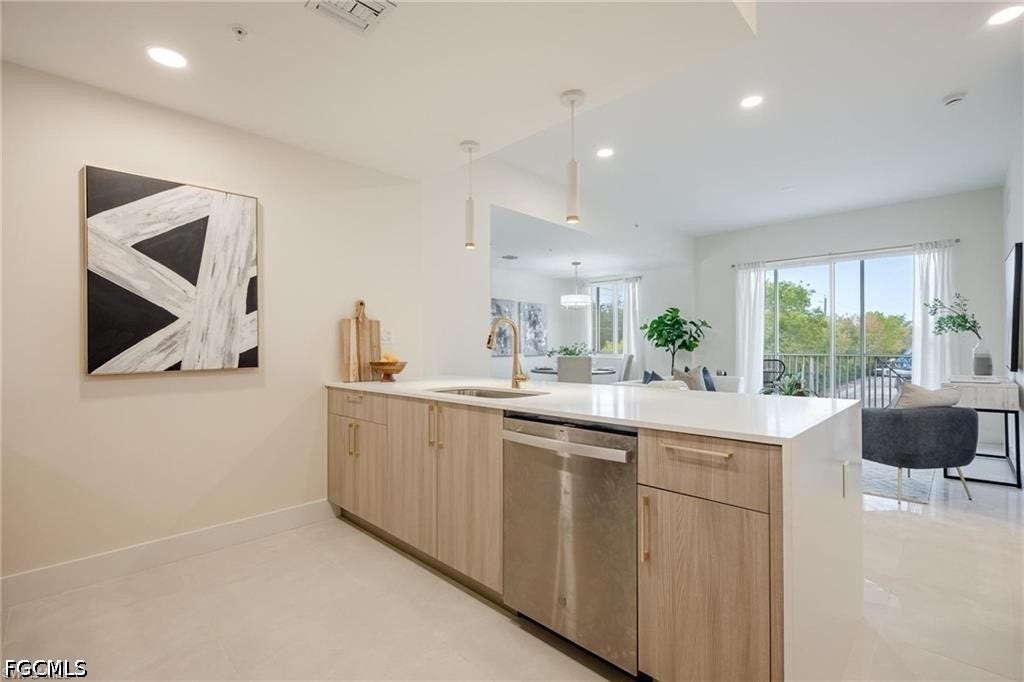 26600 ROSEWOOD POINTE Drive, #B-105, Bonita Springs, FL 34135 Kitchen with a peninsula, stainless steel dishwasher, light brown cabinetry, open floor plan, and light countertops