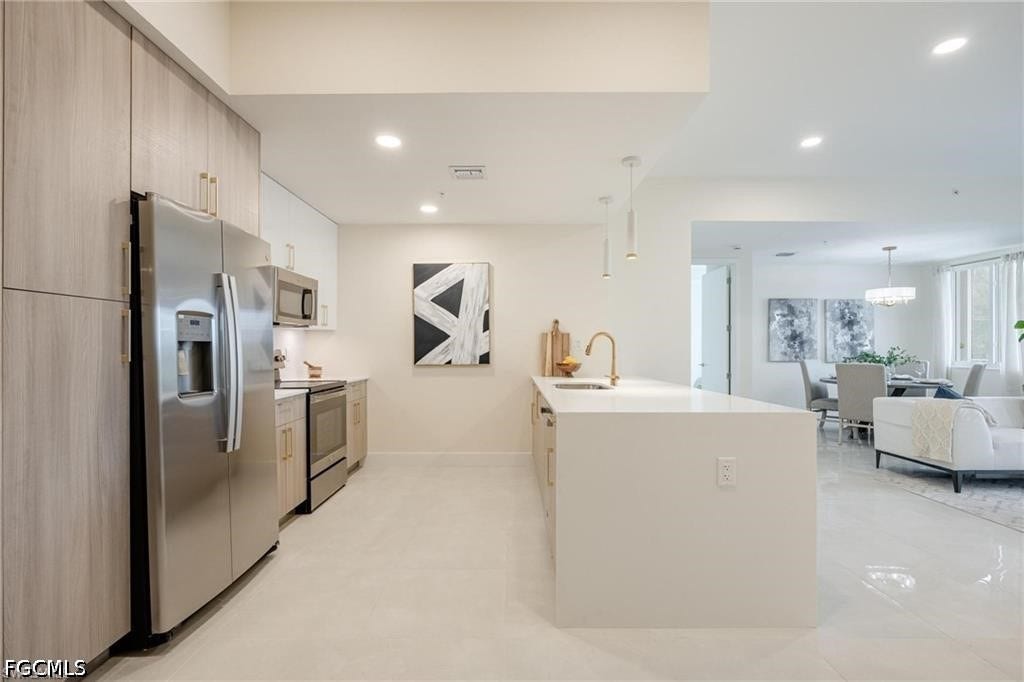 26600 ROSEWOOD POINTE Drive, #B-105, Bonita Springs, FL 34135 Kitchen featuring a sink, modern cabinets, stainless steel appliances, visible vents, and recessed lighting