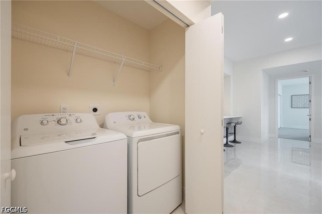 26600 ROSEWOOD POINTE Drive, #B-105, Bonita Springs, FL 34135 Clothes washing area featuring independent washer and dryer, light tile patterned floors, baseboards, laundry area, and recessed lighting