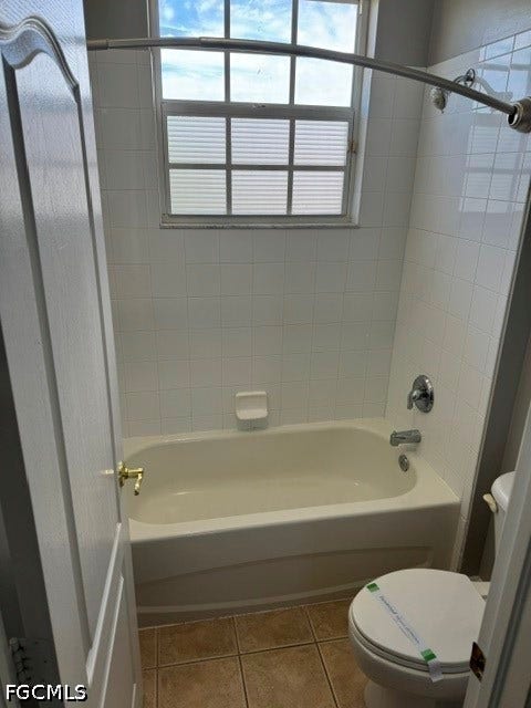 White tiled shower surround with an integrated bathtub, chrome fixtures, and a window with privacy blinds
