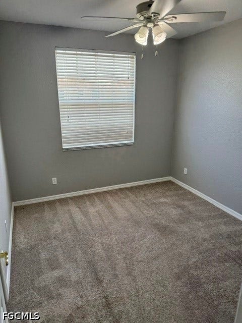 Wall-to-wall carpeting with light gray walls, window with blinds, and a ceiling fan with integrated lighting