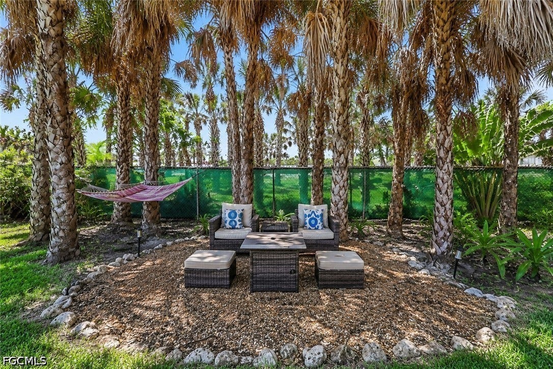 RETREAT AREA WITH OUTDOOR FURNISHING, PROPANE FIRE TABLE AND HAMMOCK.  PROPERTY BORDERS THE CATHOLIC CHURCH PROPERTY.