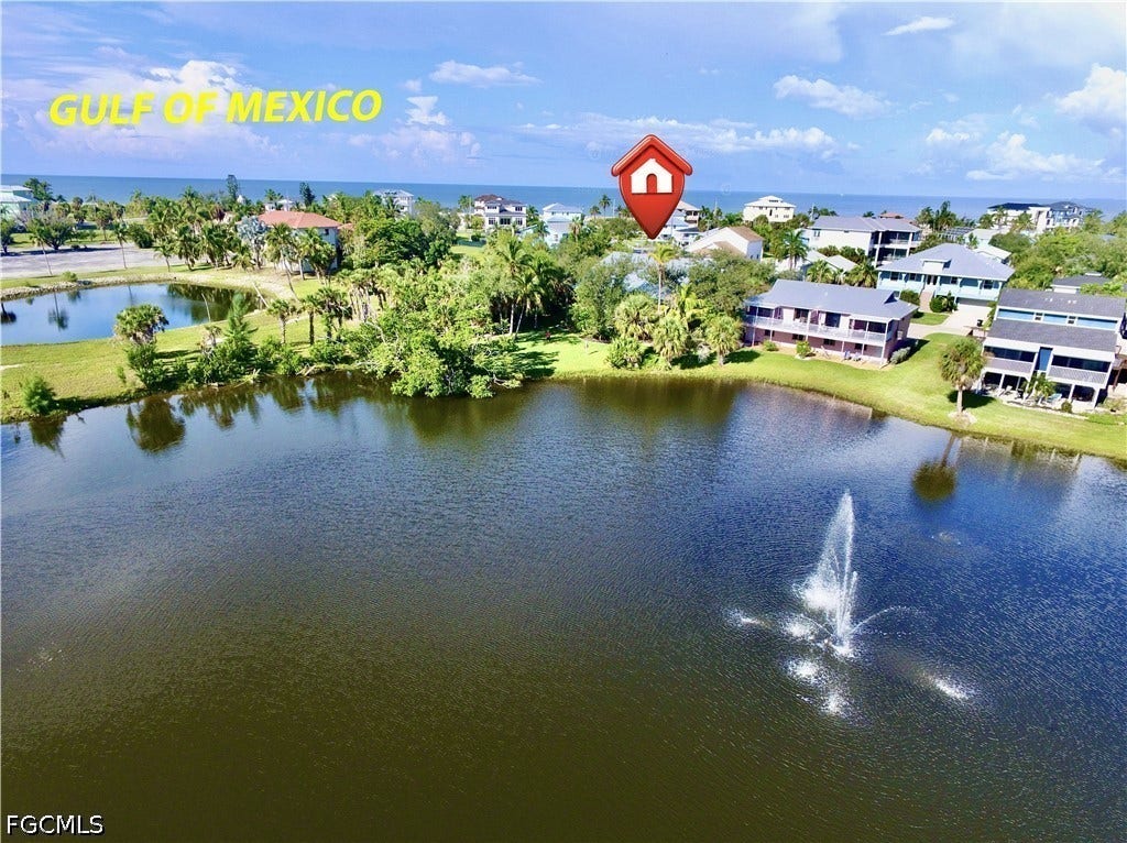 WATERFRONT PROPERTY W/LUSH GREEN LANDSCAPING BACKING UP TO A POND W/ACTIVE FOUNTAIN