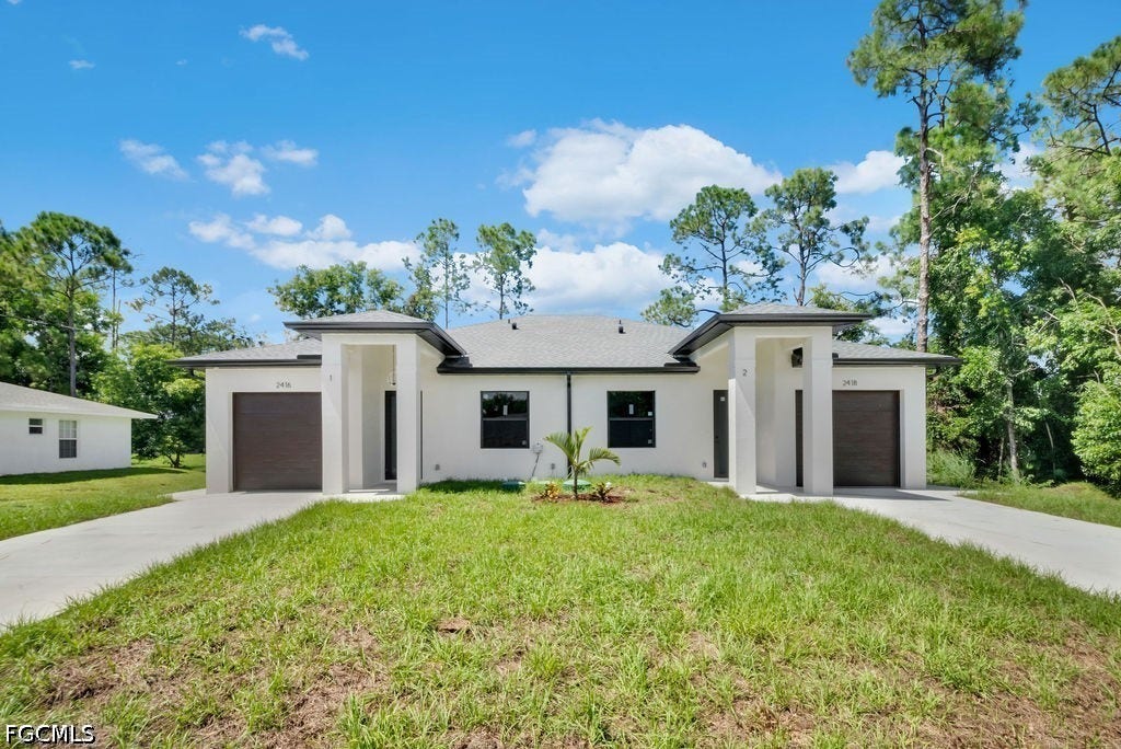 2416/2418 Joe Avenue S, Lehigh Acres, FL 33973 Contemporary duplex exterior featuring a white stucco finish, dark garage doors, and individual covered entryways