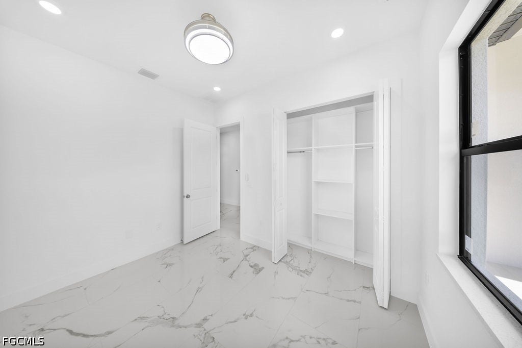 2416/2418 Joe Avenue S, Lehigh Acres, FL 33973 White walls with recessed lighting and a ceiling-mounted fixture