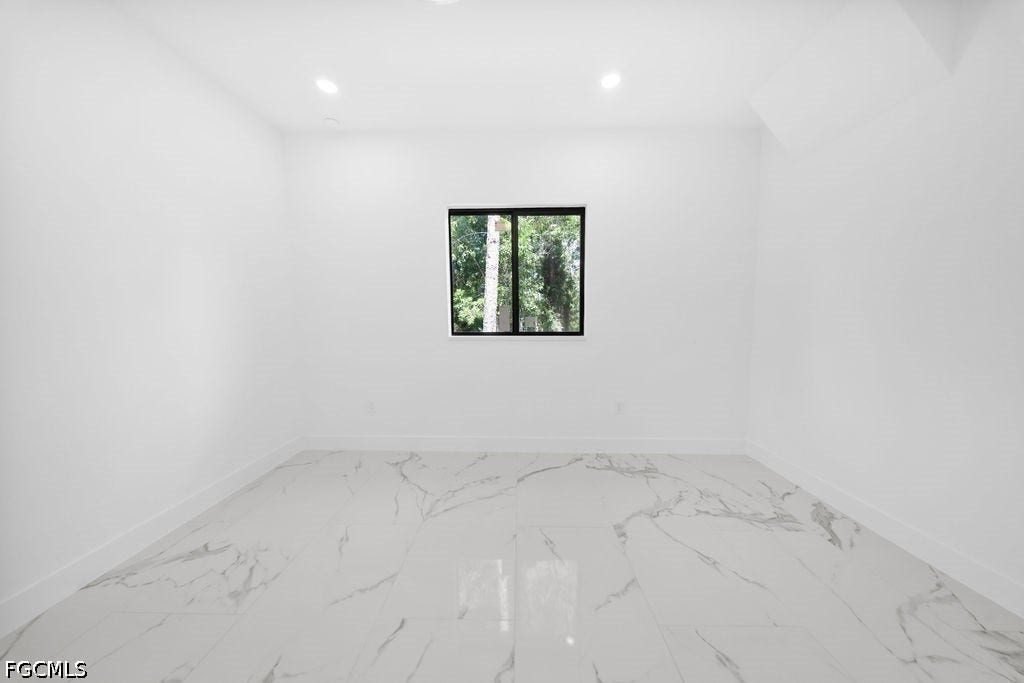 2416/2418 Joe Avenue S, Lehigh Acres, FL 33973 White walls with recessed lighting and a single window