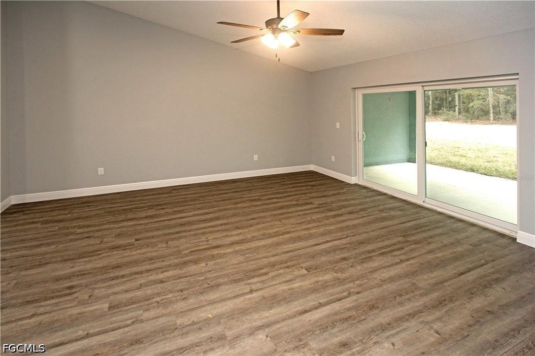 9342/9344 N Peachtree Way, Citrus Springs, FL 34434 Vaulted ceiling with a ceiling fan, wood-finish flooring, and sliding glass doors opening to an exterior concrete patio