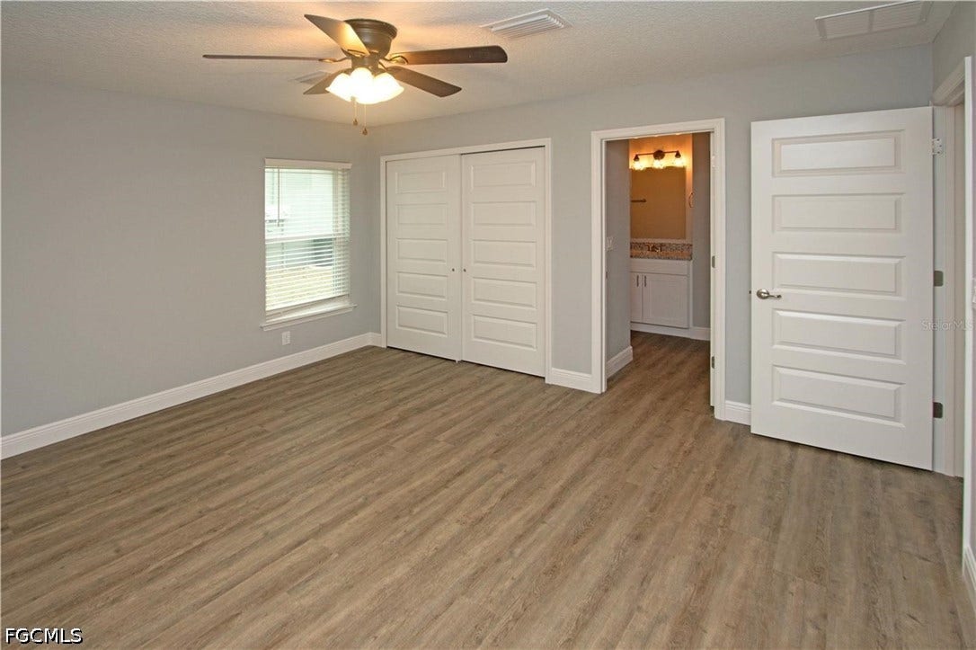 9342/9344 N Peachtree Way, Citrus Springs, FL 34434 Wood-finish flooring, ceiling fan with integrated lighting, sliding closet doors, window with blinds, and white interior doors