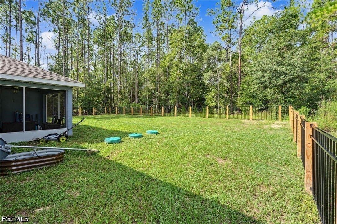 9342/9344 N Peachtree Way, Citrus Springs, FL 34434 Expansive green space with perimeter fencing and a screened-in patio