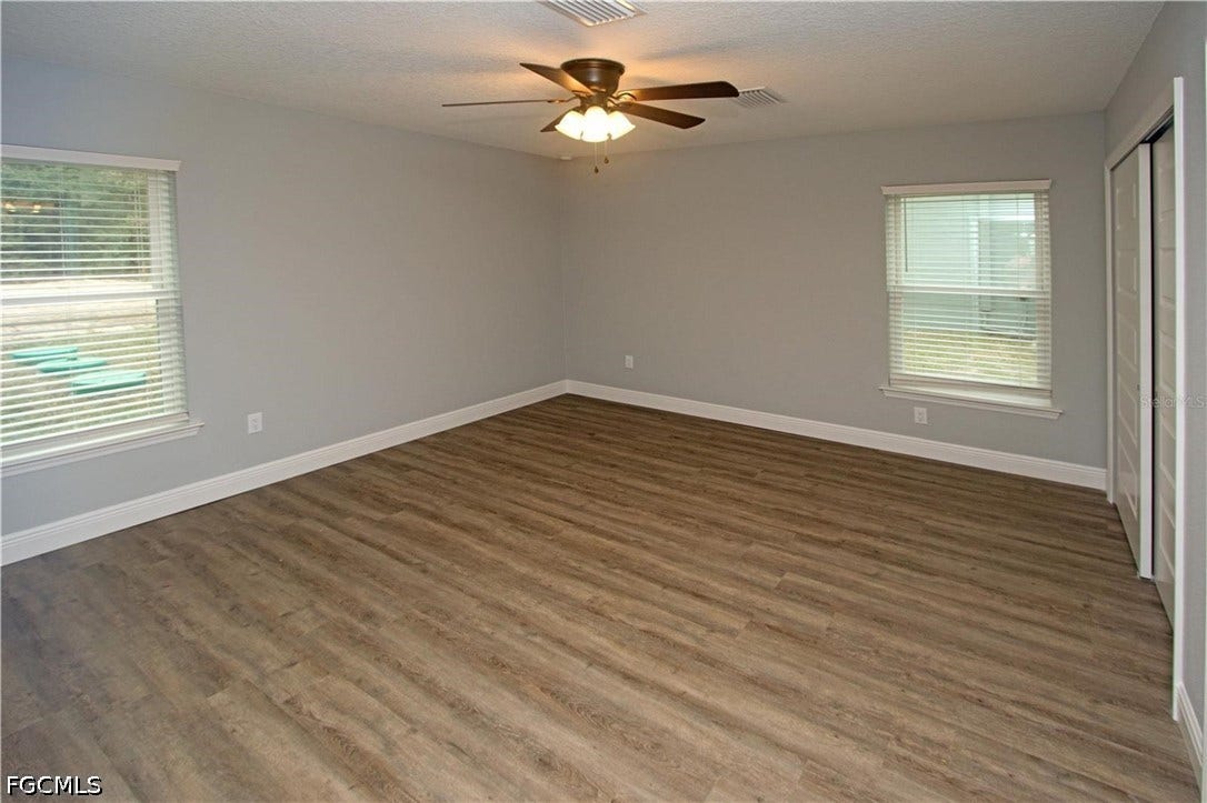 9342/9344 N Peachtree Way, Citrus Springs, FL 34434 Wood-finish flooring, light gray walls, white trim, ceiling fan, and window blinds