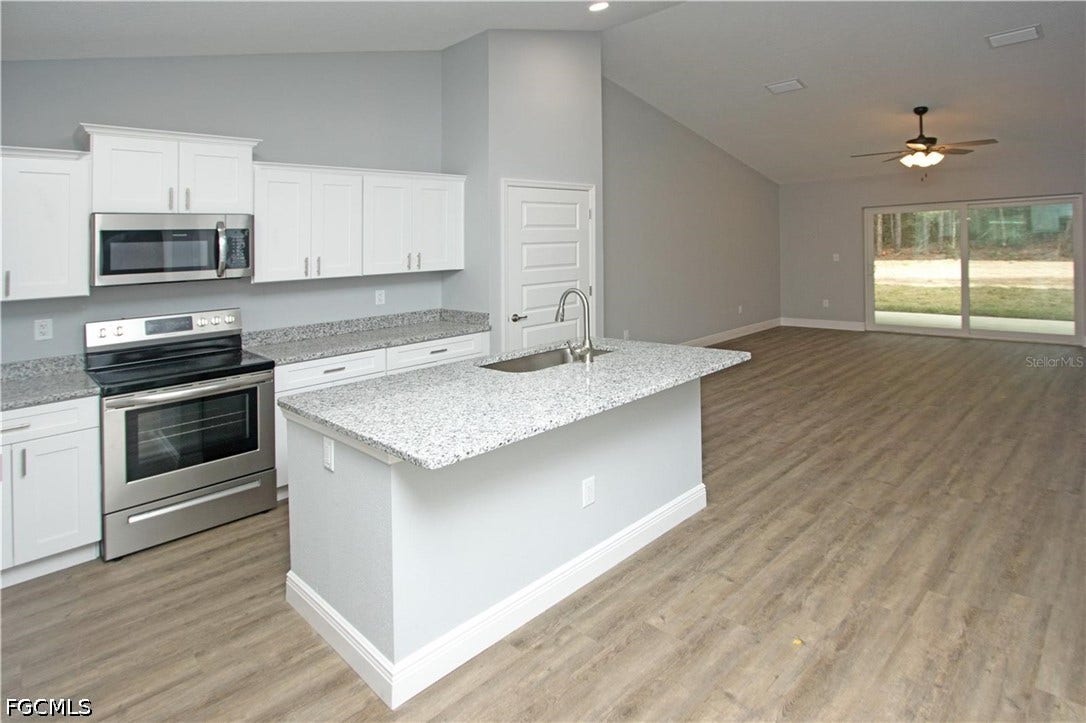 9342/9344 N Peachtree Way, Citrus Springs, FL 34434 Kitchen featuring white cabinetry, stainless steel appliances, and speckled countertops