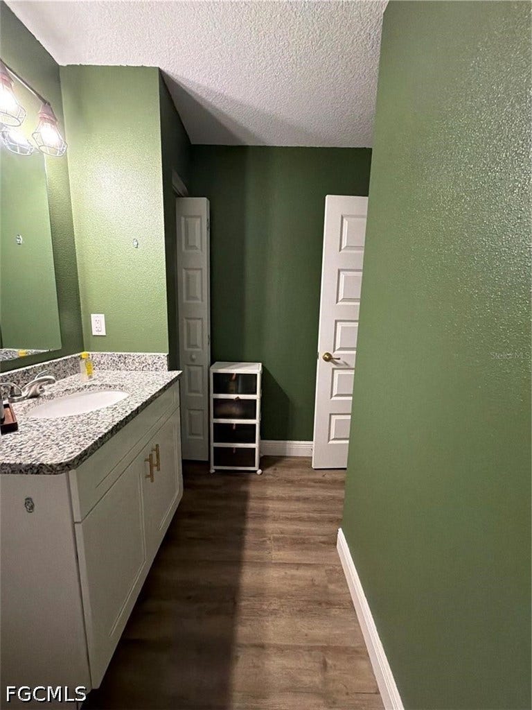 9342/9344 N Peachtree Way, Citrus Springs, FL 34434 Vanity with granite-style countertop, undermount sink, and polished chrome faucet