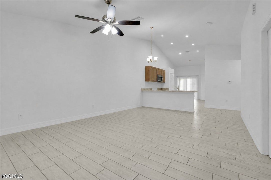 2412/2414 Richard Avenue S, Lehigh Acres, FL 33973 Vaulted ceilings, recessed lighting, and a ceiling fan enhance the main living area