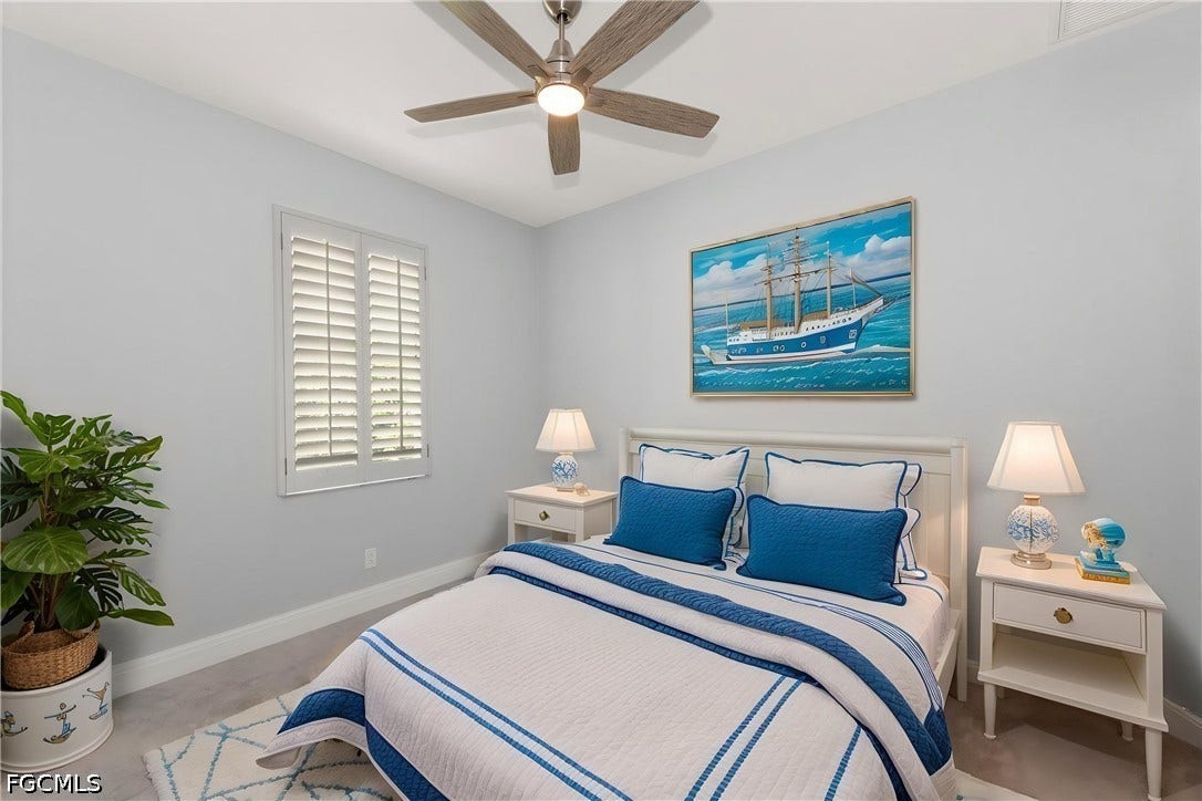 Wood-finish ceiling fan, recessed lighting, and window with plantation shutters