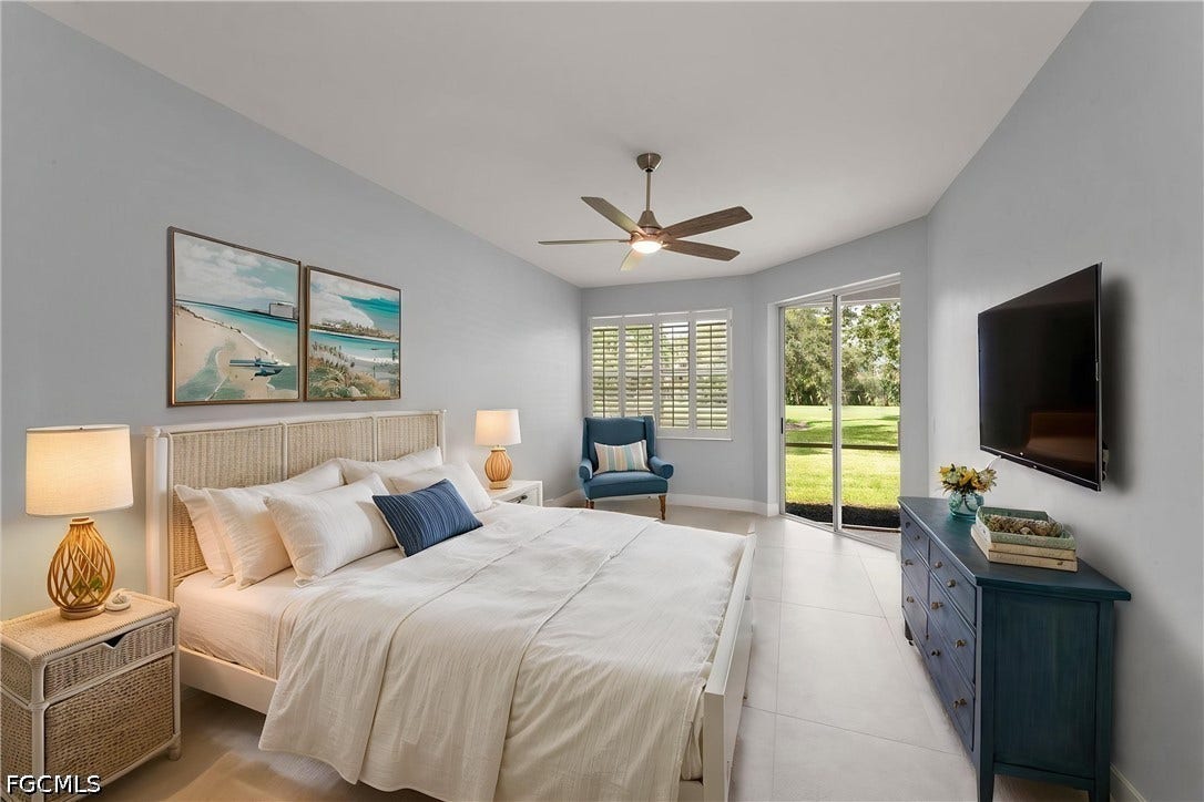 Ceiling fan with integrated lighting, a sliding glass door, plantation shutters, and light-colored tile flooring