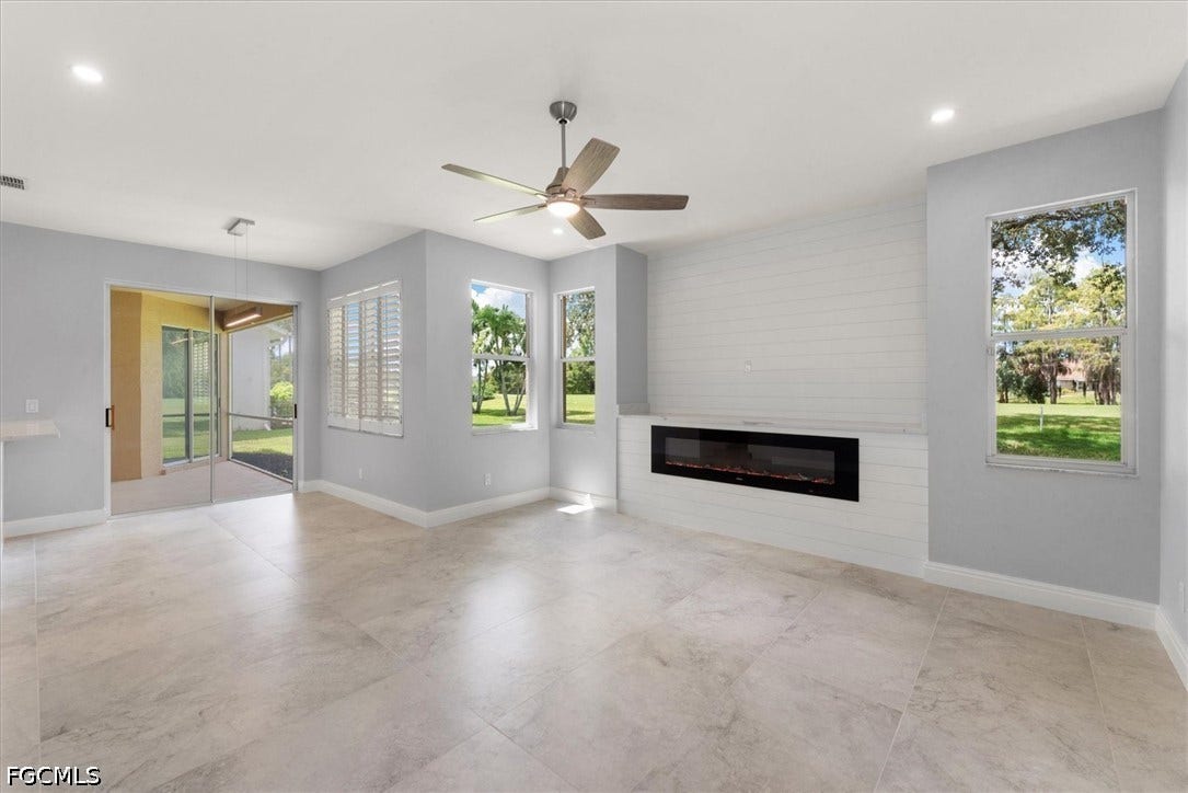 Porcelain tile flooring throughout, built-in electric fireplace, ceiling fan, and large windows with plantation shutters