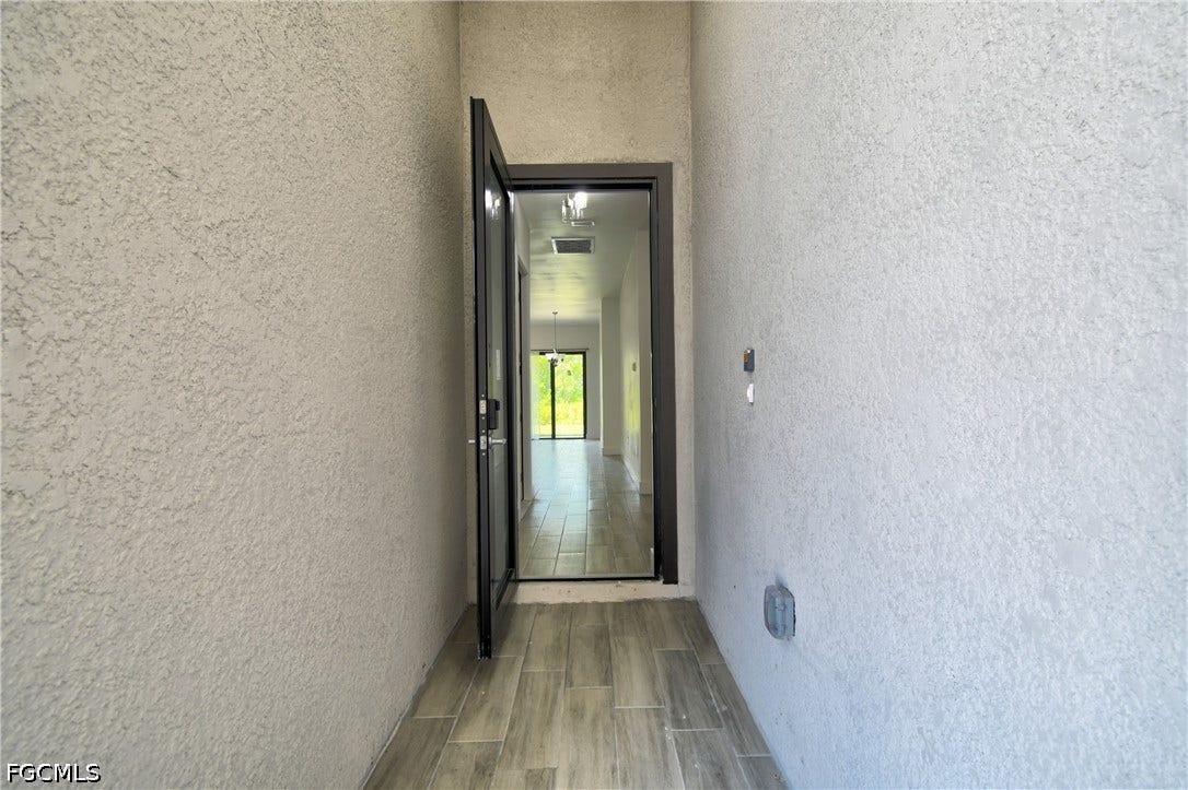 Entrance to property with stucco siding