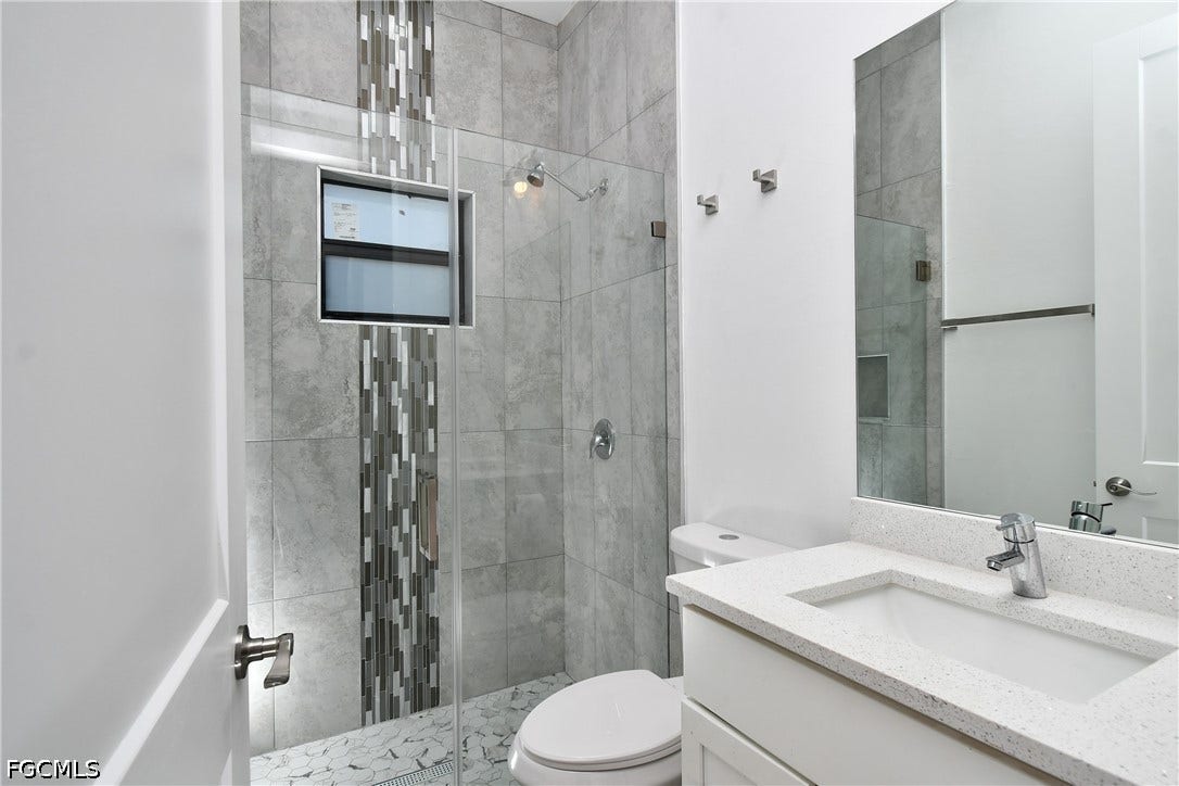 Bathroom featuring vanity and a stall shower