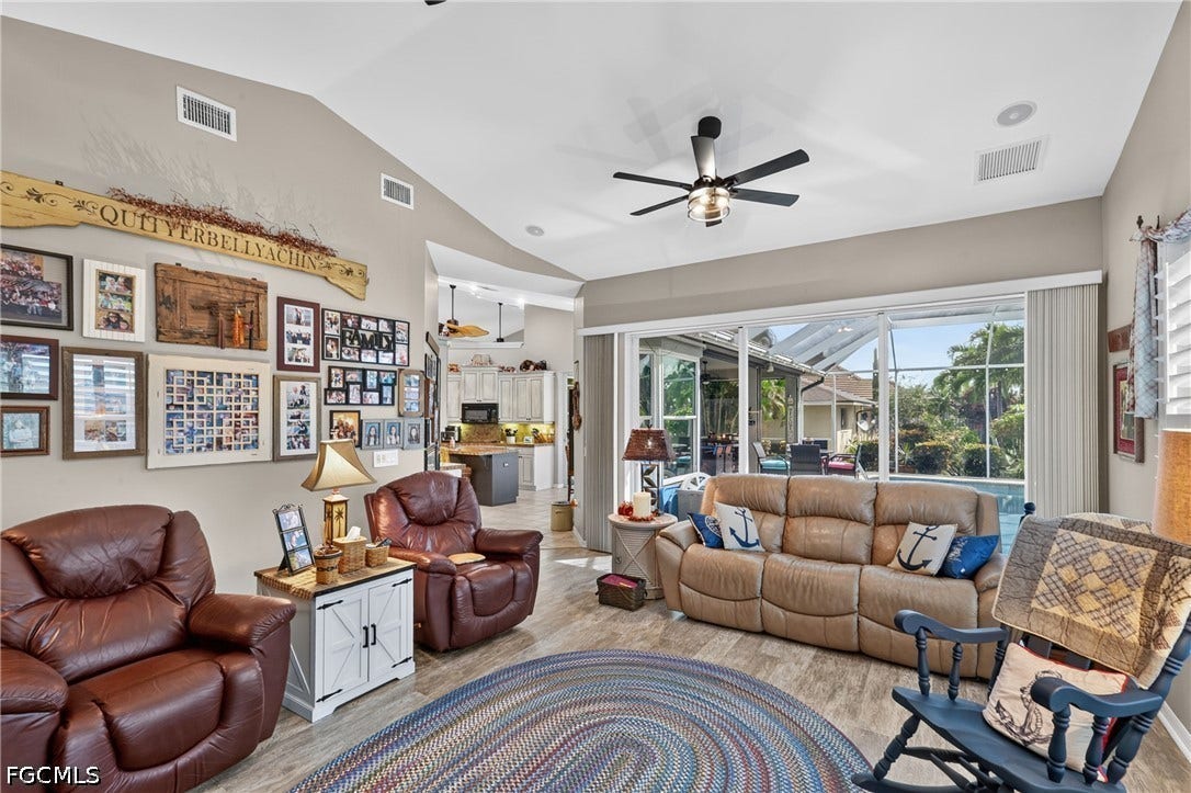 1416 SW 49th Terrace, Cape Coral, FL 33914 Wood-finish flooring, vaulted ceilings, and a ceiling fan with integrated lighting