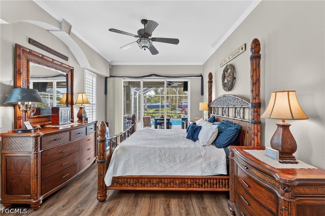 1416 SW 49th Terrace, Cape Coral, FL 33914 Wood-finish flooring, vaulted ceiling, crown molding, ceiling fan, and sliding glass door