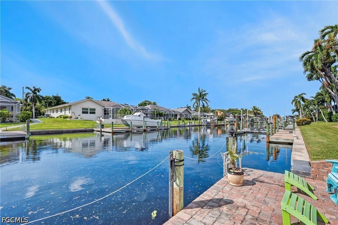 1416 SW 49th Terrace, Cape Coral, FL 33914 Waterfront property with private boat docks and a brick paver patio