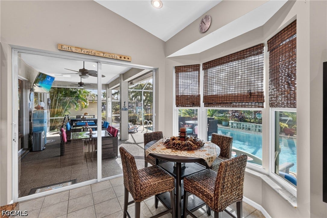 1416 SW 49th Terrace, Cape Coral, FL 33914 With sliders going out to the pool for outside dining - Tiled flooring leading to a screened patio and an exterior pool area